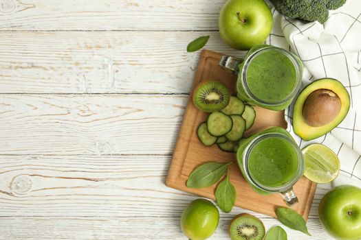 Concept of healthy food with smoothie, vegetables and fruits on wooden table