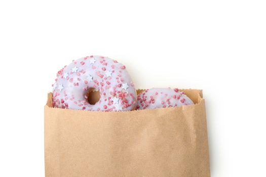 Paper bag with donuts isolated on white background