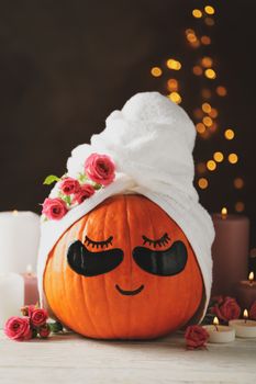 Candles and pumpkin with eye patches on brown background