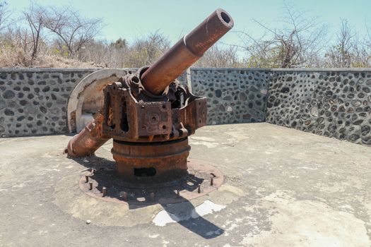 ancient war cannon located in medieval tower. Concept of protection and power. Cannon in Lombok Island, Indonesia.