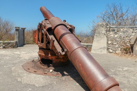 ancient war cannon located in medieval tower. Concept of protection and power. Cannon in Lombok Island, Indonesia.