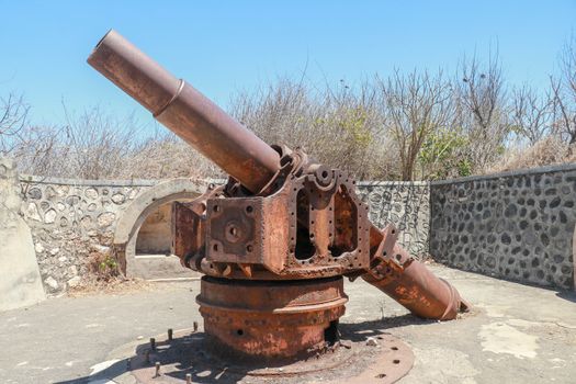 ancient war cannon located in medieval tower. Concept of protection and power. Cannon in Lombok Island, Indonesia.