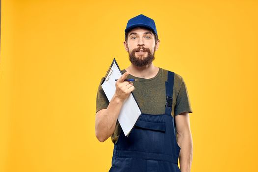 Man in working form documents transportation delivery service yellow background. High quality photo