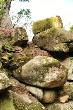 Stacked rocks plenty of moss in a Leafy garden with large trees in Sintra, Lisbon