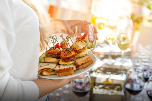 Guest holding a plate of different snacks at the event