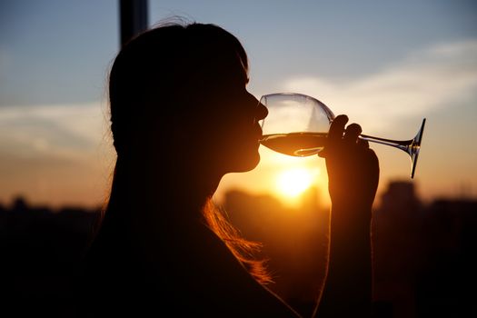 Girl with wine glass. Black silhouette