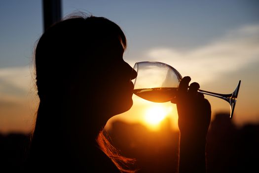 Girl with wine glass. Black silhouette