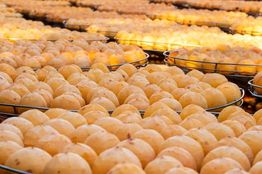 Making process of sun exposuring drying peeled dried persimmon in a sieve, autumn preserved food concept.