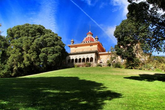 Monserrate palace between Leafy and green garden with large trees in Sintra, Lisbon