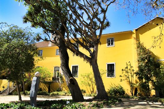 Beautiful yellow house with colorful garden in Oeiras, Lisbon, Portugal