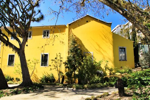 Beautiful yellow house with colorful garden in Oeiras, Lisbon, Portugal