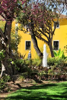 Beautiful yellow house with colorful garden in Oeiras, Lisbon, Portugal