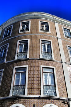 Old colorful and majestic tiled facades with vintage streetlight in Lisbon streets in Spring.