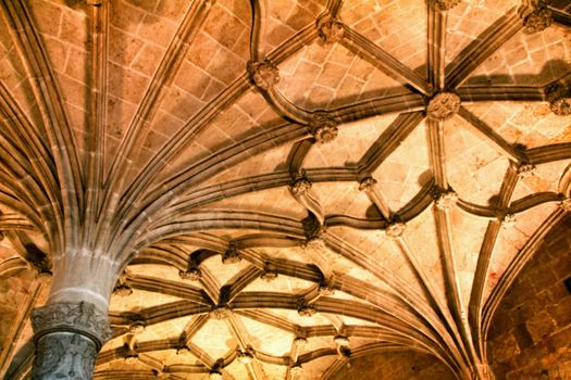 Arches and monumental columns with carved stone details of Santa Maria de Belem in Lisbon, Portugal