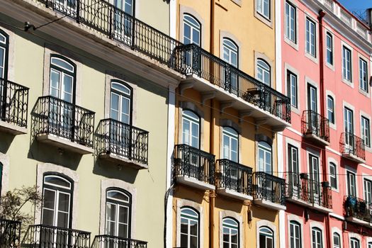 Old colorful and majestic tiled facades with vintage streetlight in Lisbon streets in Spring.