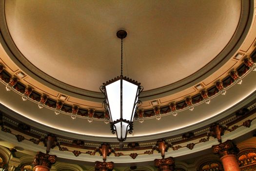Beautiful coffered ceiling with vintage lamp in a vintage coffe in Lisbon