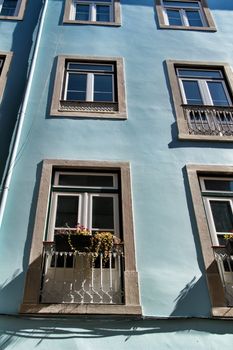 Old colorful and majestic tiled facades with vintage streetlight in Lisbon streets in Spring.