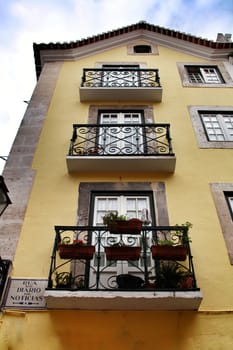 Narrow and colorful streets, majestic facades, windows and balconies of Lisbon, Portugal