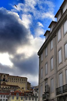 Old colorful and beautiful facades with vintage streetlight in Lisbon streets in Spring. Clothesline in the facade with hanging clothes
