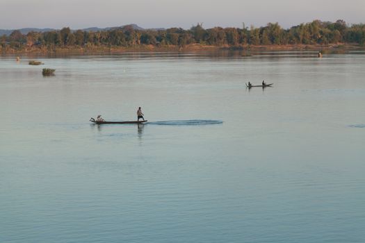 Muong Khong Laos 1.12.2012 Mekong river at sunset in blue hour and traditional fishing boats with nets . High quality photo