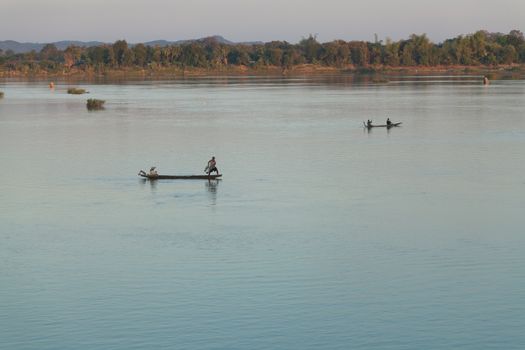 Muong Khong Laos 1.12.2012 Mekong river at sunset in blue hour and traditional fishing boats with nets . High quality photo