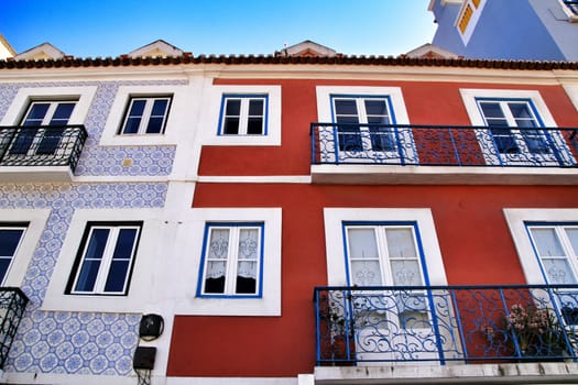 Old colorful houses and streets of Lisbon, Portugal in Spring. Majestic facades and old street lights.