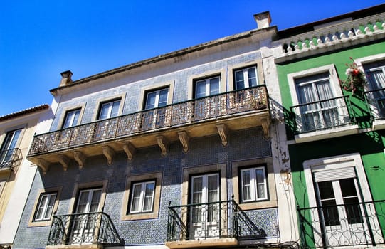 Old colorful houses and streets of Lisbon, Portugal in Spring. Majestic facades and old street lights.