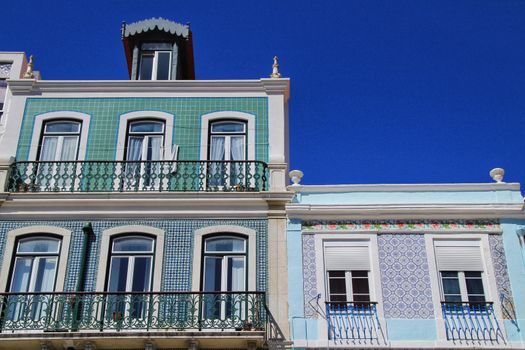 Old colorful houses and streets of Lisbon, Portugal in Spring. Majestic facades and old street lights.