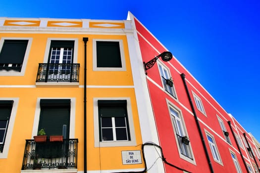 Old colorful houses and streets of Lisbon, Portugal in Spring. Majestic facades and old street lights.