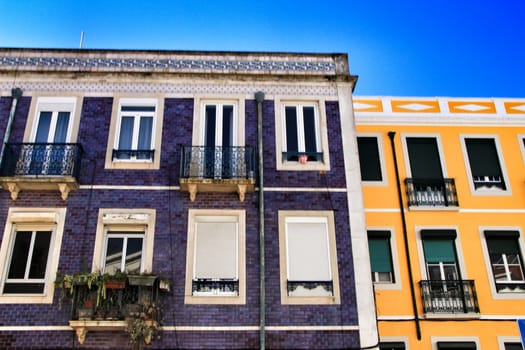 Old colorful houses and streets of Lisbon, Portugal in Spring. Majestic facades and old street lights.