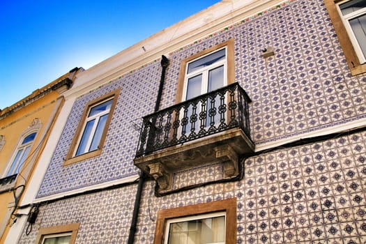 Old colorful houses and streets of Lisbon, Portugal in Spring. Majestic facades and old street lights.