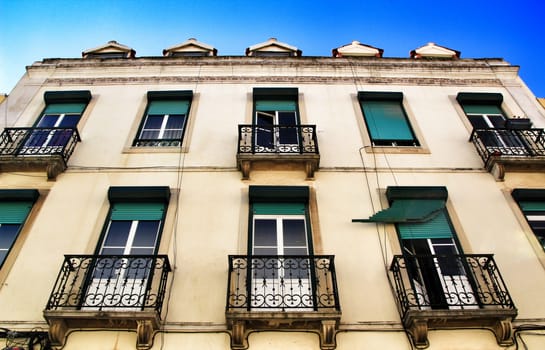 Old colorful houses and streets of Lisbon, Portugal in Spring. Majestic facades and old street lights.