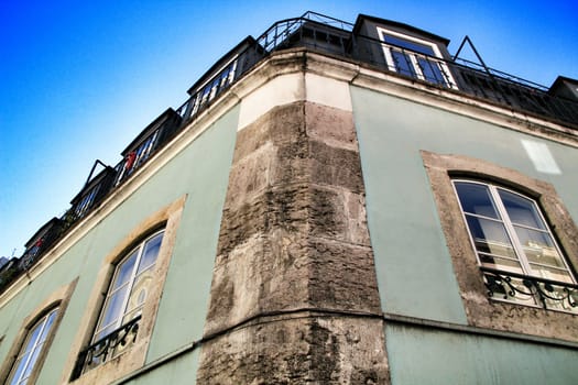 Old colorful houses and streets of Lisbon, Portugal in Spring. Majestic facades and old street lights.