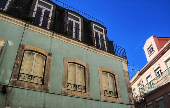 Old colorful houses and streets of Lisbon, Portugal in Spring. Majestic facades and old street lights.