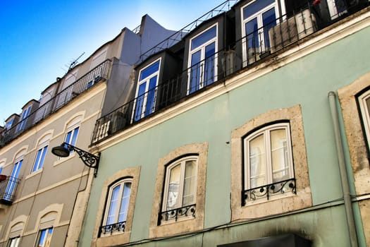 Old colorful houses and streets of Lisbon, Portugal in Spring. Majestic facades and old street lights.