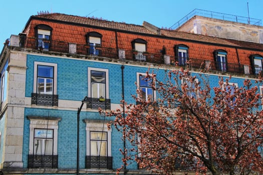 Old colorful houses and streets of Lisbon, Portugal in Spring. Majestic facades and old street lights.