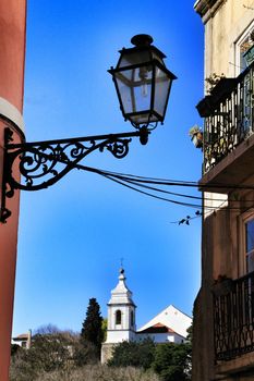 Old colorful and beautiful facades with vintage streetlight in Lisbon streets in Spring. 