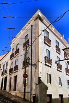 Old colorful and beautiful facades with vintage streetlight in Lisbon streets in Spring. 