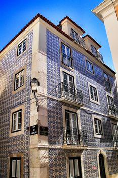 Old colorful and beautiful facades with vintage streetlight in Lisbon streets in Spring. 