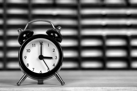 Clock marking winter time change over checkered background