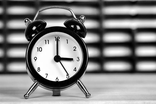 Clock marking winter time change over checkered background