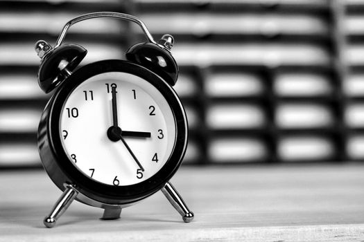 Clock marking winter time change over checkered background
