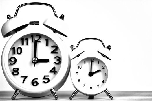 Clocks marking winter time change over white background