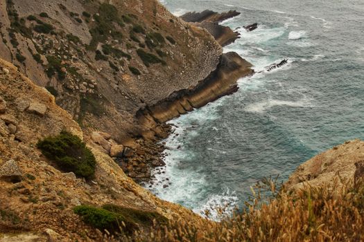 Views of the wild Atlantic Ocean with beautiful cliffs in Cape Espichel, Portugal