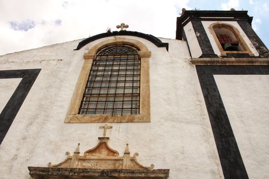 Old and majestic antique church in Obidos village, Portugal, under cloudy sky