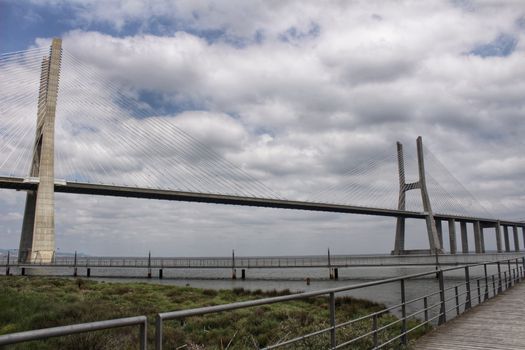 Vasco Da Gama perspectives under cloudy sky in Lisbon. Drama.