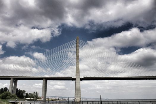 Vasco Da Gama perspectives under cloudy sky in Lisbon. Drama.