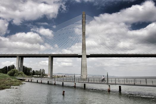 Vasco Da Gama perspectives under cloudy sky in Lisbon. Drama.