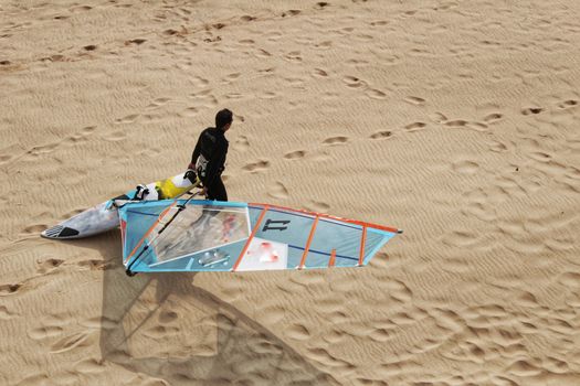 Surfers at Guincho beach under cloudy sky in spring Portugal