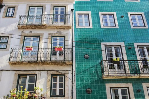 Old colorful and majestic tiled facades with vintage streetlight in Lisbon streets in Spring.